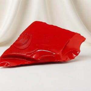 Natural red coral rough in an irregular uncut form for lapidary inlay, artisan jewelry crafting and collector display.