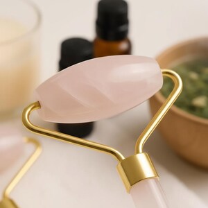 Rose quartz roller tool for skincare routine morning and night facial massage