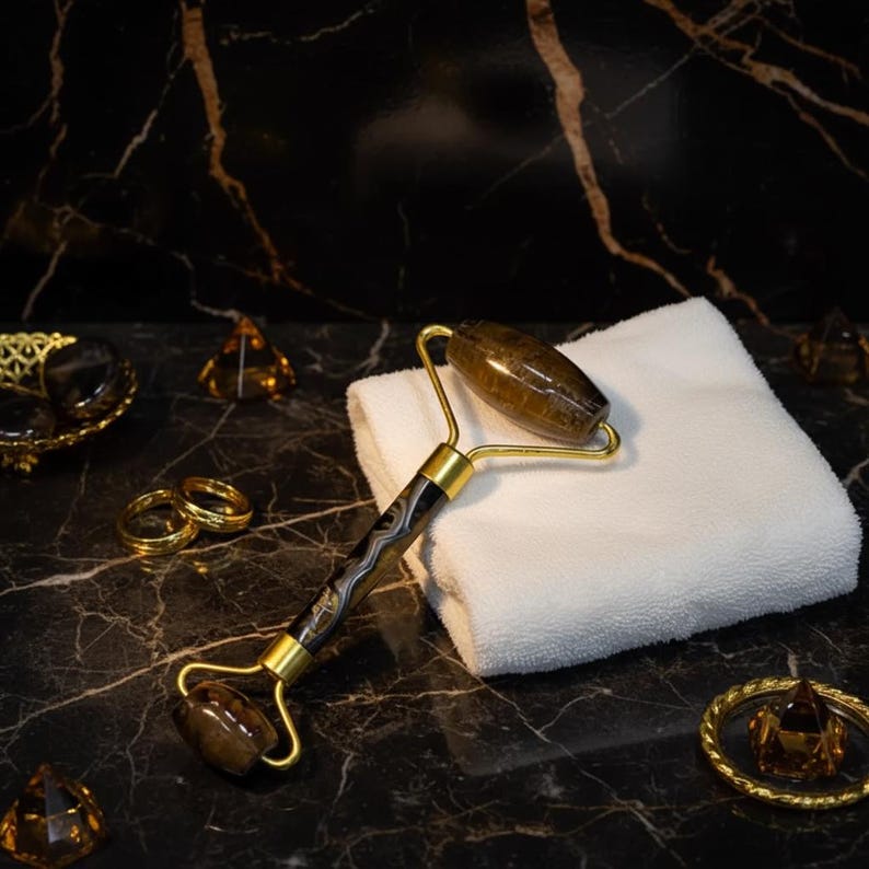 natural tiger eye facial roller golden brown stone with gold frame under eye de puff tool