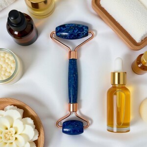 Lapis lazuli facial roller close-up showing genuine blue stone with pyrite flecks, handmade beauty tool