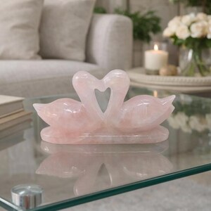 High-resolution shot of a 100 percent natural rose quartz love birds sculpture showcasing unique crystalline patterns and light pink color.