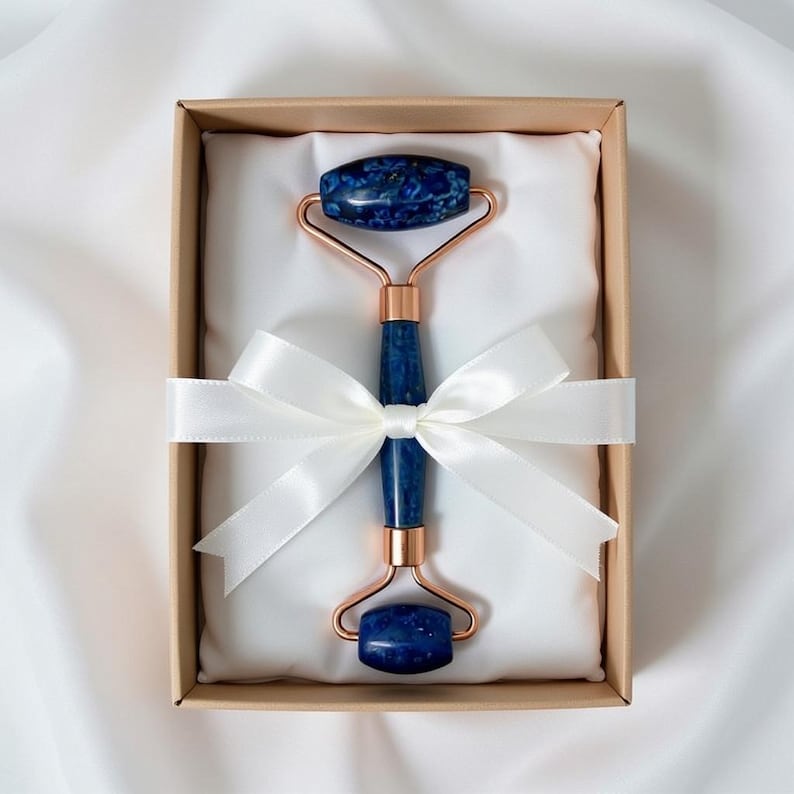 Cooling lapis lazuli facial roller on countertop, dual end crystal face massager for daily skincare