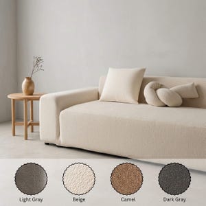 May include: A beige sofa with a square pillow and a decorative bolster. A small wooden side table with a vase is to the left. The image also shows four color swatches: light gray, beige, camel, and dark gray.