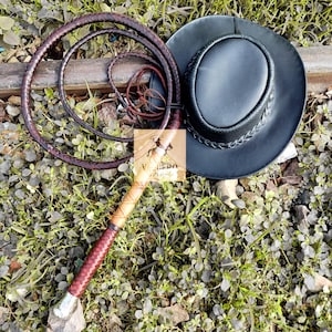 Handheld image showing grip and length of leather bullwhip