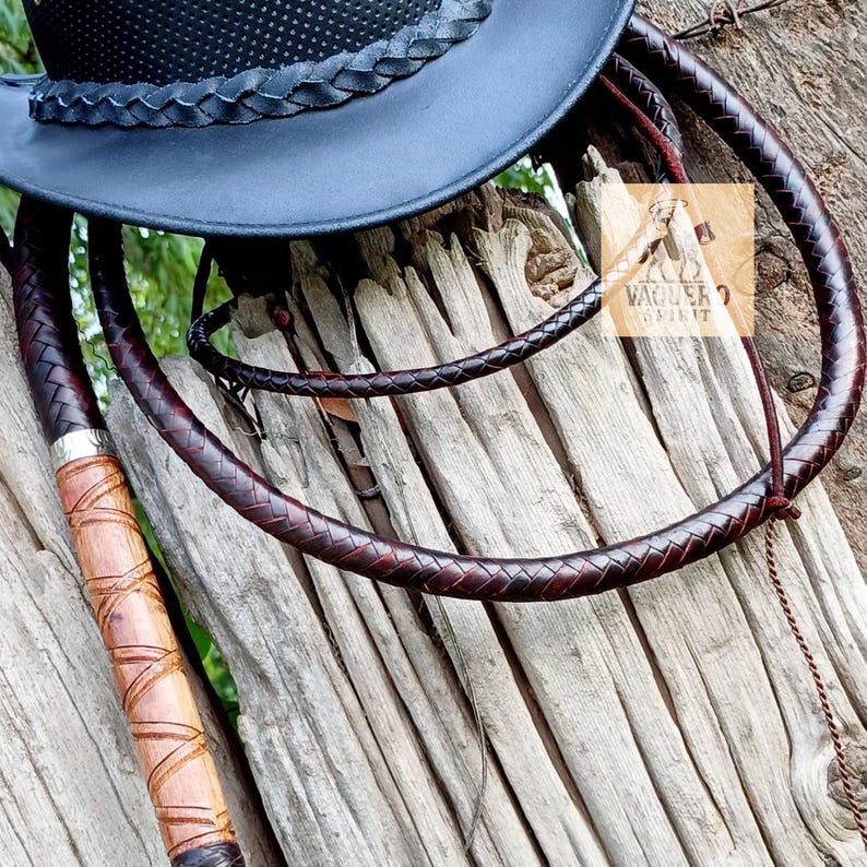 Bullwhip laid on rustic wooden surface showcasing craftsmanship