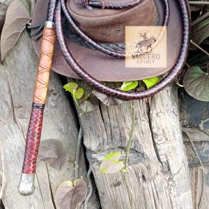 Long polished wooden handle of handcrafted bullwhip