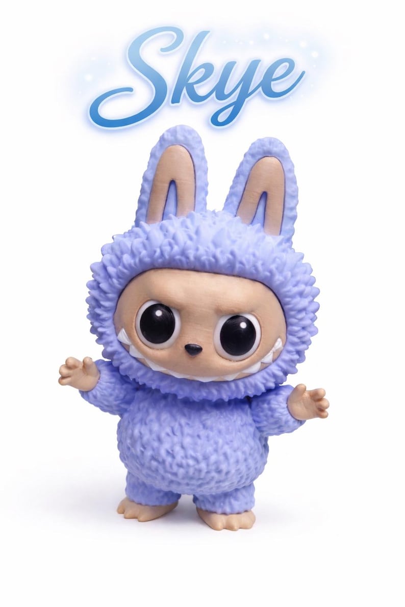May include: A collectible figurine of a creature in a fuzzy, light purple bunny suit with large, black eyes and a toothy grin. The figurine has tan ears and feet. The name "Skye" is written above the figure in a stylized, light blue font.