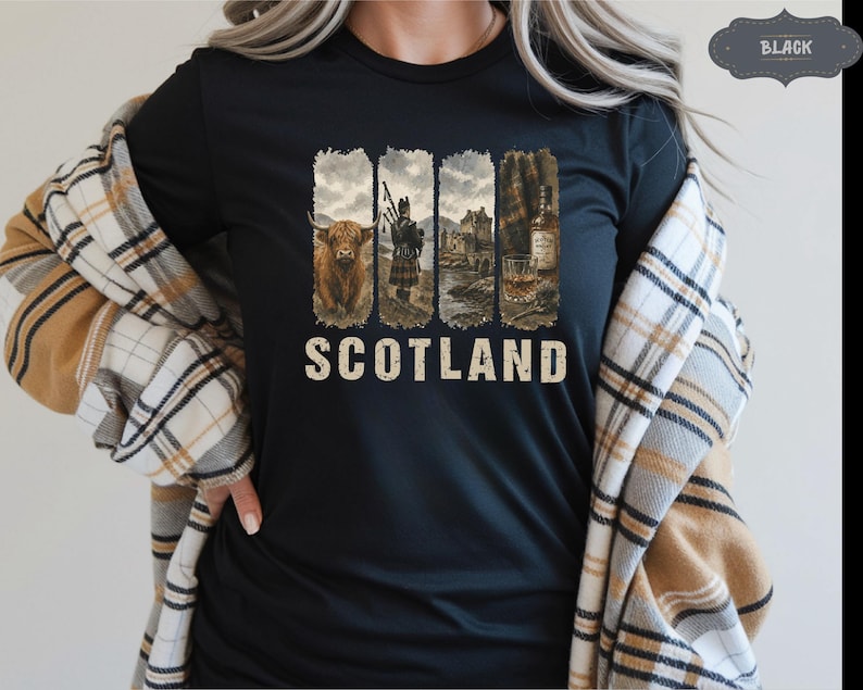 May include: Black t-shirt with a graphic design featuring Scottish imagery. The design includes a Highland cow, a bagpiper, a castle, and a whiskey bottle with a glass. The word "SCOTLAND" is printed in a vintage font.