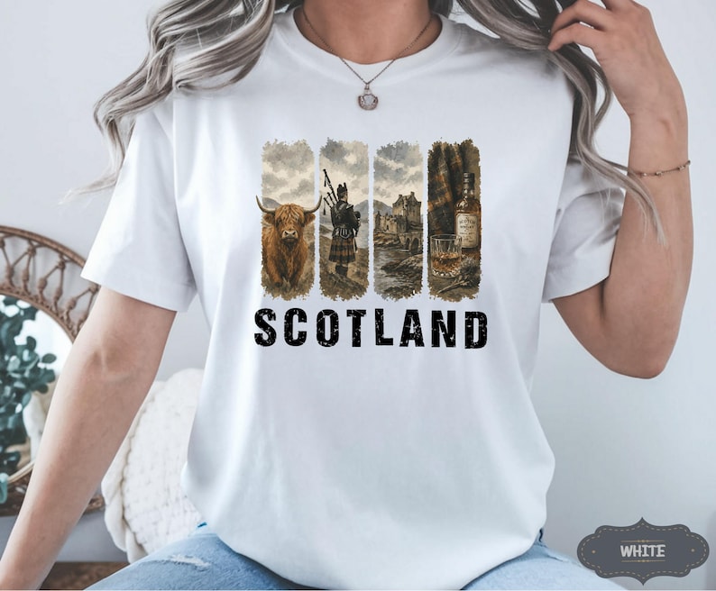 May include: White t-shirt featuring a design with four vertical panels. The panels depict a Highland cow, a bagpiper, a castle, and a bottle of whiskey. The word "SCOTLAND" is printed in bold black letters below the panels.