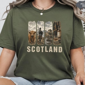 May include: Military green t-shirt featuring a graphic design with four vertical panels. The panels depict a Highland cow, a bagpiper, a castle, and a bottle of whiskey. The word "SCOTLAND" is printed in a distressed font.