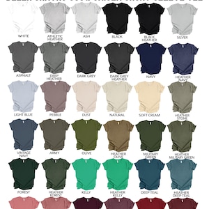 May include: Color chart of Bella Canvas 3001 unisex short sleeve tees in various colors, including white, black, navy, and green. The image displays a range of shades, from light blue to maroon, with each color labeled for easy selection.