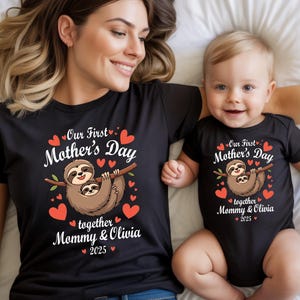May include: Matching black t-shirts and baby bodysuit with a sloth graphic for Mother's Day. The shirts read "Our First Mother's Day together Mommy & Olivia 2025" with red hearts.