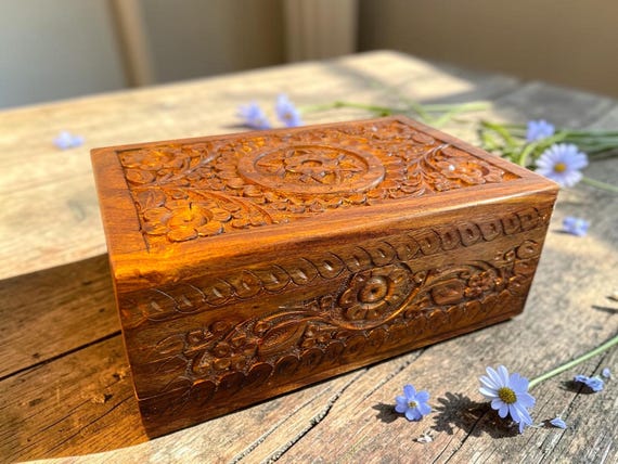 Hand-carved rosewood puzzle box with a hidden secret lock mechanism — you have to solve it to get inside, making it as much a curiosity as a keepsake.