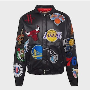 May include: Black leather jacket with multiple team patches, including the Lakers, Bulls, and Knicks. The jacket has a red collar and lining, with a ribbed waist and cuffs. A stylish piece for sports fans.