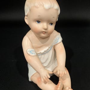 Vintage Bisque Porcelain Piano Baby Figurine: White Gown, Blue Trim