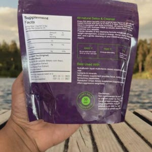 May include: A purple supplement packet with white text, held by a hand. The packet lists supplement facts and is labeled "All-natural Detox & Cleanse." It includes a "Money Back Guarantee" seal.