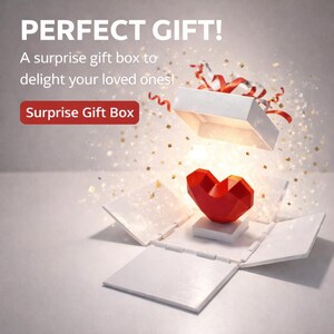 Pode incluir: Uma caixa de presente branca aberta com um coração geométrico vermelho dentro. A caixa tem a tampa ligeiramente aberta e fitas. O texto "PERFECT GIFT!" e "Surprise Gift Box" são visíveis.