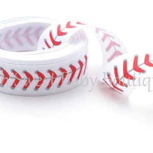 May include: White grosgrain ribbon with a red baseball stitch design.