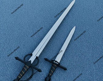 May include: Two swords with silver blades and black handles with gold accents rest on a blue surface. The larger sword has a complex hilt design, while the smaller one has a simpler crossguard. The swords are likely decorative or for historical reenactment.