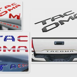 May include: A collection of Tacoma truck emblem replacements in various styles. Includes red, black, and American flag-themed lettering. The image shows the emblems on a white background and on a truck.