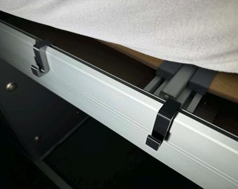 Mounting hooks for clipping into the bed frame of the Adria Twin SGX - set consisting of two pieces.
