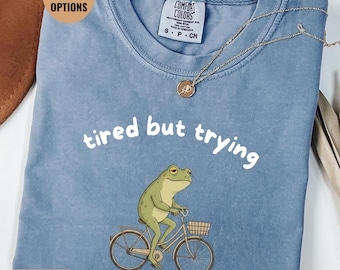Tired But Trying Frog Shirt, Funny Frog Meme T Shirt, Cute Frog On Bike Tee, Mental Health Humor Shirt, Relatable Aesthetic Gift