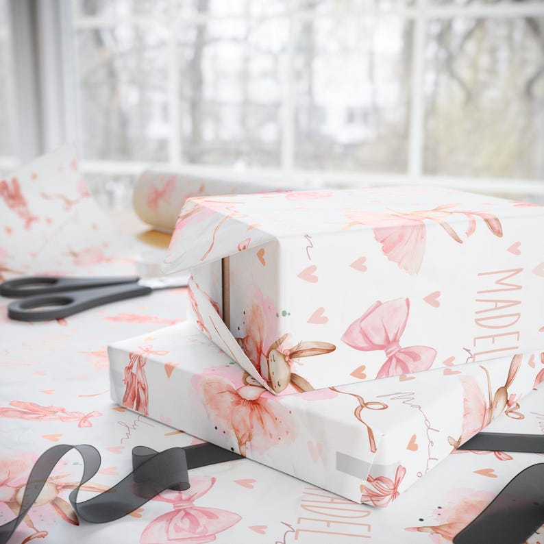 Custom birthday wrapping paper featuring ballerina bunnies and hearts being wrapped around gifts.