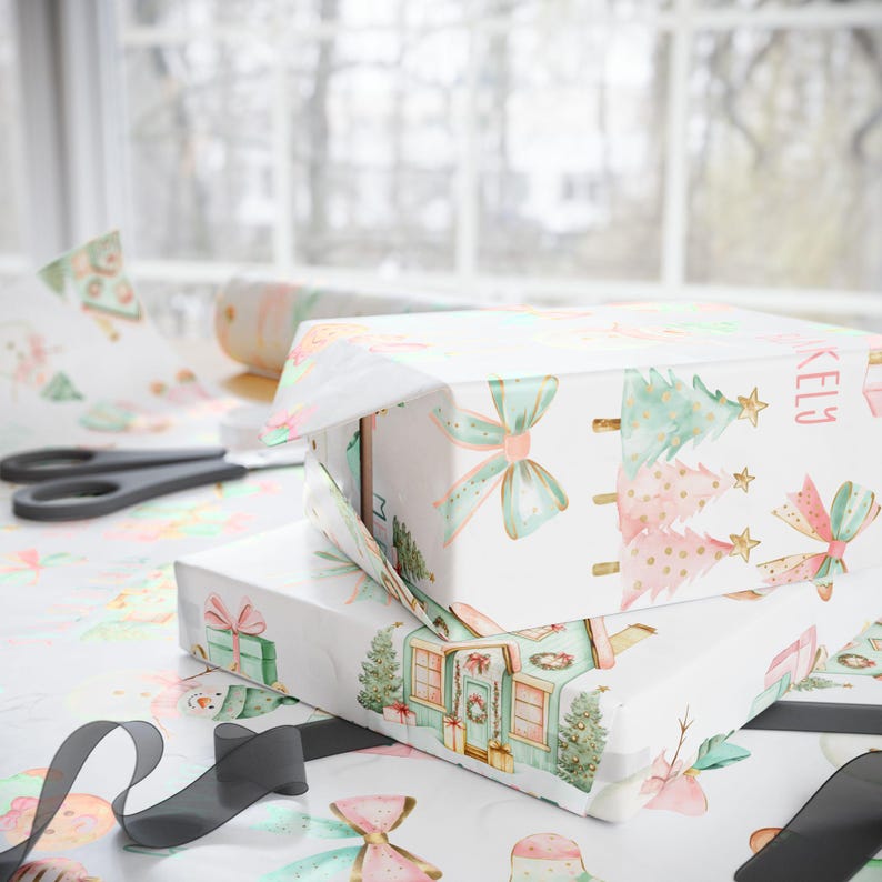 Personalized pastel Christmas wrapping paper for girls featuring gingerbread men, holiday houses, and custom name design