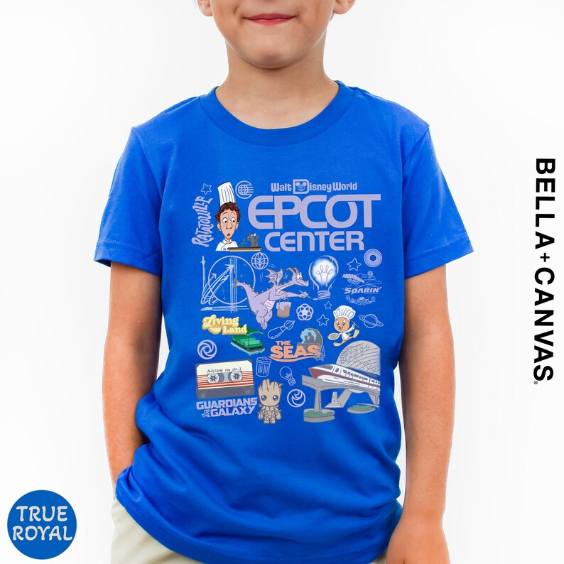 A young boy wearing a blue t-shirt with various Disney-themed graphics and text, including the words 'Epcot Center', 'DisneyWorld', and 'Bella Canvas'.
