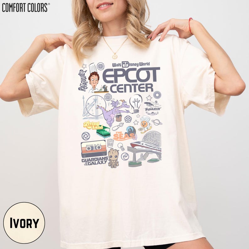 A woman wearing a white t-shirt with various Disney-themed graphics and text, including the words "EPCOT CENTER" and "Disney World".