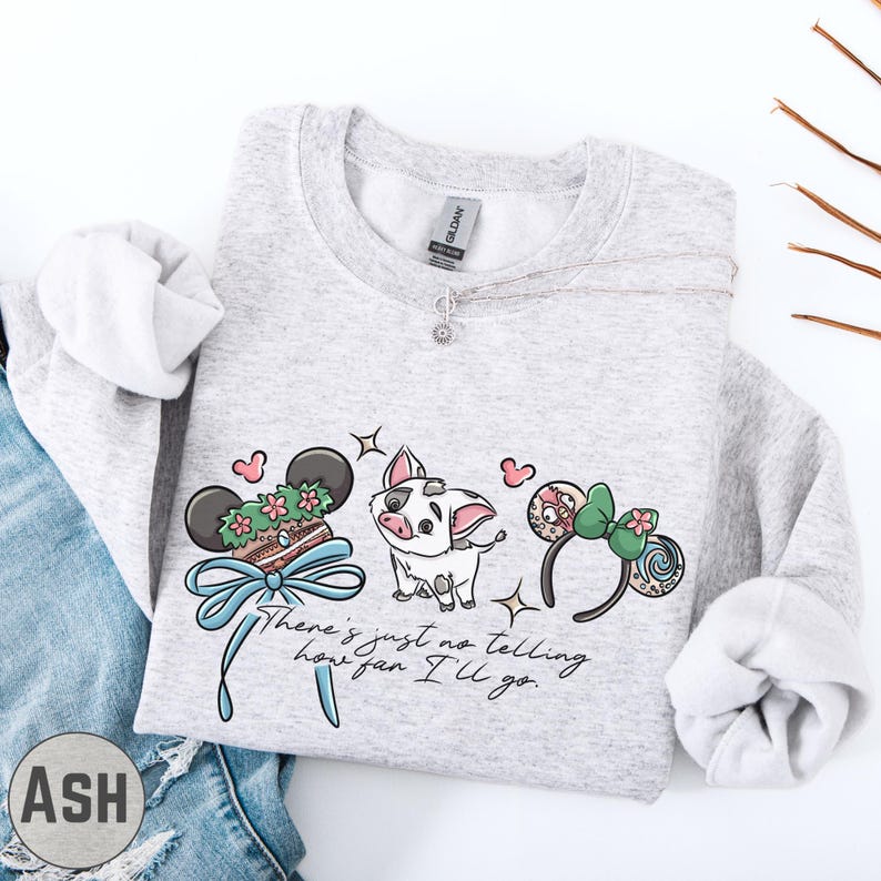 A gray sweatshirt with a graphic design featuring a pig, a pair of headphones, and a ribbon, along with the text "There's just no telling how far I'll go".