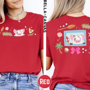 A red t-shirt with a cartoon pig and various colorful illustrations on the back.