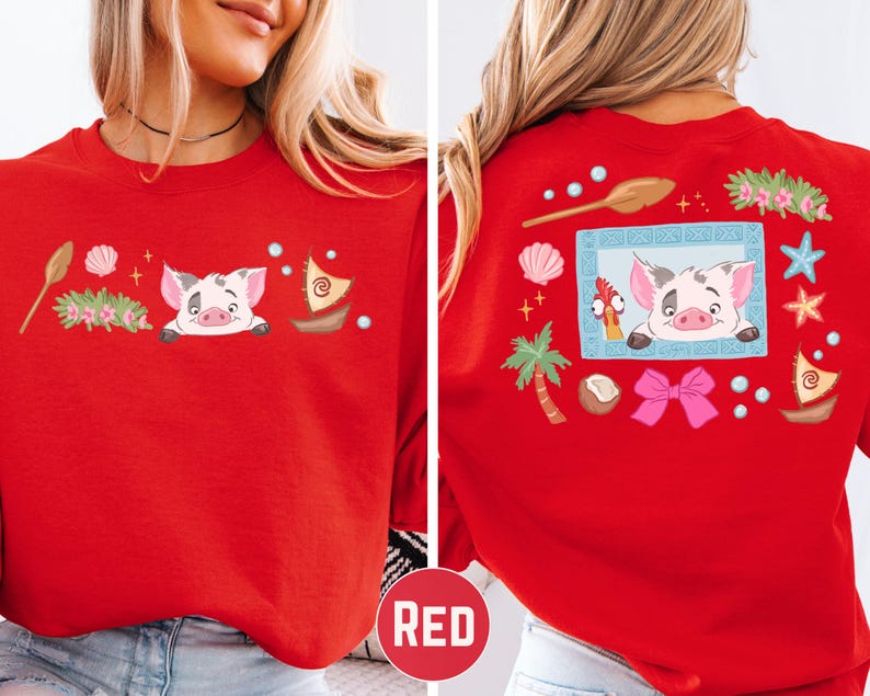 A red t-shirt with a cartoon pig design and various decorative elements, including a boat, palm tree, starfish, and other whimsical objects.
