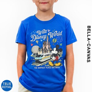 A young boy wearing a blue t-shirt with a Disney World graphic and text.