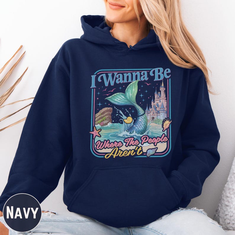 A navy blue hoodie with a graphic design featuring a mermaid and the text "I Wanna Be Where The People Aren't".