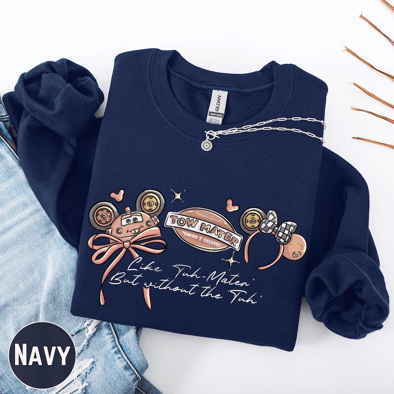 Navy sweatshirt with a graphic design featuring cartoon-style characters and text.
