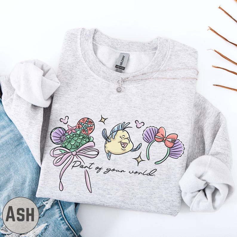 A gray sweatshirt with a graphic design featuring a cartoon character and the text "Part of your world" printed on it.