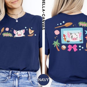 a woman wearing a navy blue t-shirt with a colorful graphic design on the back.