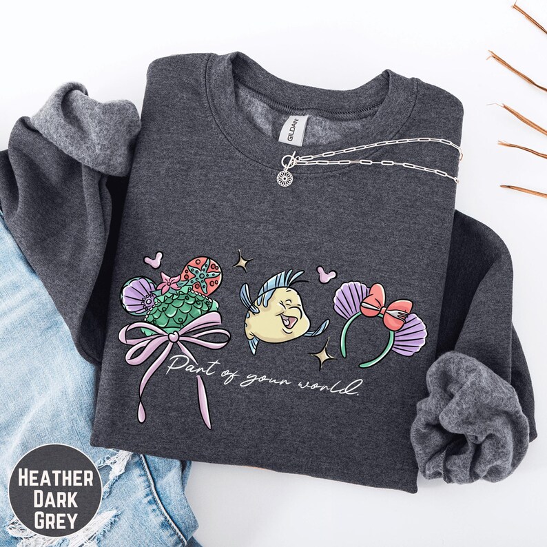 A gray sweatshirt with a graphic design featuring a cartoon character and the text "Part of your world" printed on it.