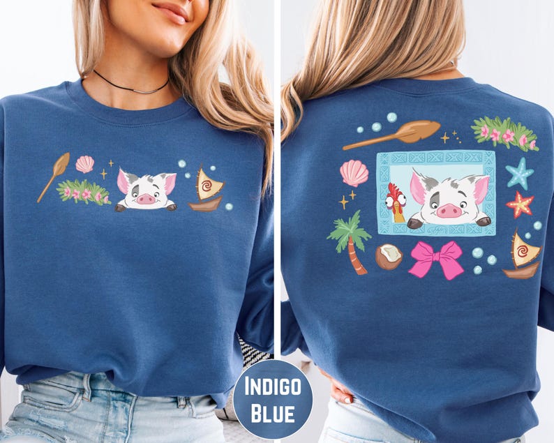 a woman wearing a blue sweatshirt with a cartoon pig design on the front and back.