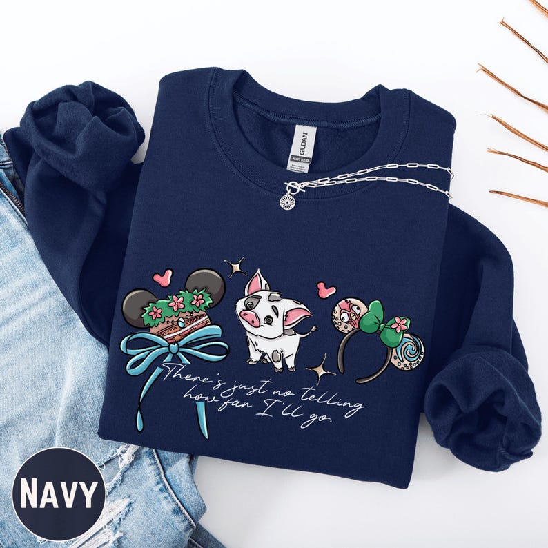 A navy blue sweatshirt with a graphic design featuring a pig, Mickey Mouse ears, and a ribbon, along with the text "There's just no telling how you'll go".