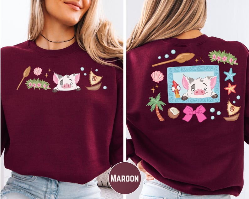 A woman wearing a burgundy sweater with a cartoon pig design and various decorative elements on the back.