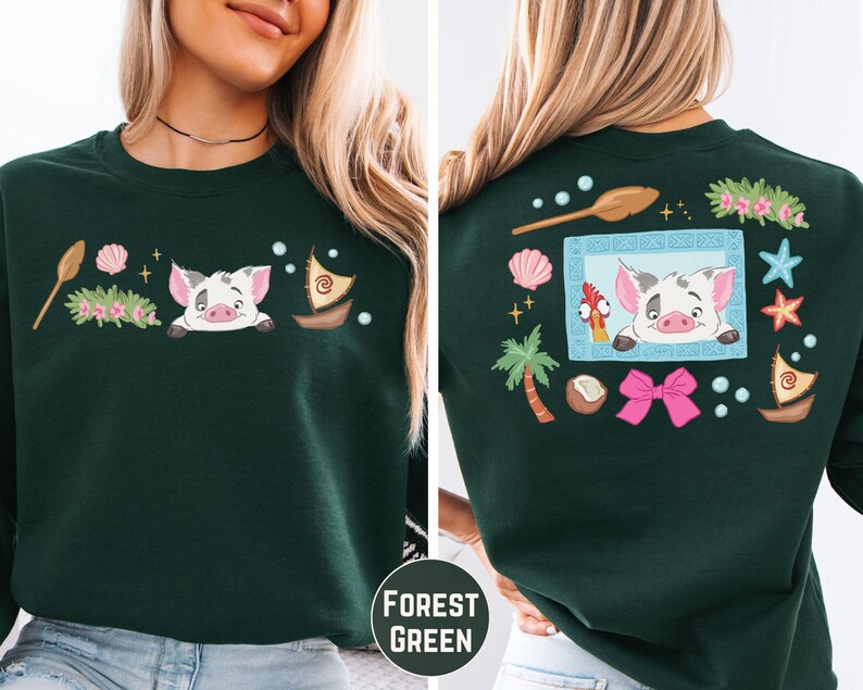 A woman wearing a green sweater with a cartoon pig and various decorative elements on the back.