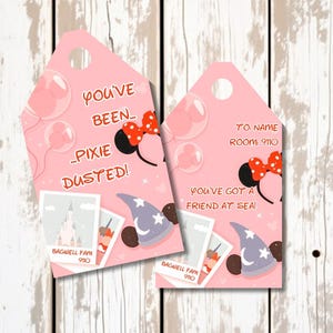 May include: Two pink gift tags with cartoon illustrations. One tag reads "You've been Pixie Dusted!" and the other says "You've got a friend at sea." Both tags feature Minnie Mouse ears, a wizard hat, and a castle.