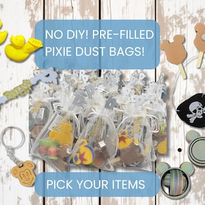 May include: A collection of pre-filled party favor bags with white organza fabric, accompanied by yellow rubber ducks, a light blue key-shaped wand, a black pirate eye patch, and various mouse-shaped charms. Text reads: NO DIY! PRE-FILLED PIXIE DUST BAGS! PICK YOUR ITEMS.