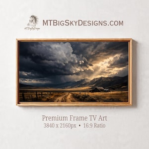 May include: A framed landscape print featuring a dramatic sky over a rural scene. The artwork depicts a dirt road leading towards a small building, with mountains in the background. The image includes the text "MTBIGSKYDESIGNS.COM" and "Premium Frame TV Art".