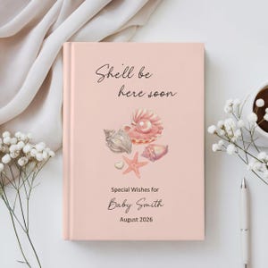 May include: A light pink baby shower guest book with the text "She'll be here soon" and "Special Wishes for Baby Smith August 2026". The cover features watercolor illustrations of seashells and a starfish.