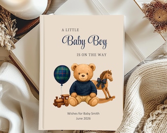 May include: A baby shower book with the text "A Little Baby Boy Is On The Way." The cover features a teddy bear, rocking horse, train, and a plaid balloon. The book is cream-colored with navy blue text.