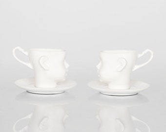 DOLL HEAD Set of two white porcelain cups with saucers