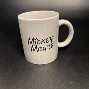 May include: A handmade wooden sign with the text "Welcome to our home" in a handwritten style. The sign is painted white with black lettering and a distressed finish, suitable for indoor or outdoor use.